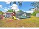 Lush backyard with a pool, playhouse and ample room for activities at 842 Cinnamon Dr, Winter Haven, FL 33880