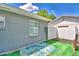 Serene backyard featuring a lush green lawn with a rug, perfect for relaxation and outdoor enjoyment at 842 Cinnamon Dr, Winter Haven, FL 33880