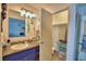 Bathroom with granite-topped vanity, bright lighting, and organized storage at 842 Cinnamon Dr, Winter Haven, FL 33880