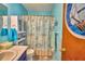 Cozy bathroom with blue walls, a vessel sink, and nautical themed shower curtain at 842 Cinnamon Dr, Winter Haven, FL 33880