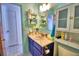 Cozy bathroom with blue walls, a vessel sink, and nautical themed shower curtain at 842 Cinnamon Dr, Winter Haven, FL 33880