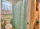 Bathroom featuring turtle-themed shower curtain, bright lighting, and neutral tile at 842 Cinnamon Dr, Winter Haven, FL 33880