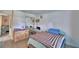 View of a bedroom with plank flooring and mirrored closet, filled with natural light at 842 Cinnamon Dr, Winter Haven, FL 33880