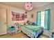 Bright bedroom features a playful aesthetic with vibrant colors and natural light from the window at 842 Cinnamon Dr, Winter Haven, FL 33880