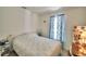 Bedroom featuring a window with blue curtains and a cozy bed with anchor themed spread at 842 Cinnamon Dr, Winter Haven, FL 33880