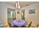 Bright dining room with a blue mosaic table and modern chandelier lighting at 842 Cinnamon Dr, Winter Haven, FL 33880