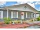 Charming single-story home with a covered front porch and decorative landscaping at 842 Cinnamon Dr, Winter Haven, FL 33880