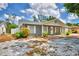Well-maintained single-story home with a gray brick exterior and manicured landscaping at 842 Cinnamon Dr, Winter Haven, FL 33880