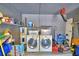 Well-organized garage featuring a washer, dryer, and water heater for added convenience at 842 Cinnamon Dr, Winter Haven, FL 33880