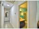 View from the hallway leading to a bathroom with blue walls and tile flooring at 842 Cinnamon Dr, Winter Haven, FL 33880