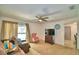 A living room featuring paneled walls, neutral-toned furniture, and abundant natural light at 842 Cinnamon Dr, Winter Haven, FL 33880