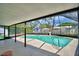Relaxing screened-in pool area with lush landscaping and inviting turquoise water at 842 Cinnamon Dr, Winter Haven, FL 33880