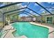 Inviting screened-in pool area with crystal blue water, surrounded by a patio at 842 Cinnamon Dr, Winter Haven, FL 33880