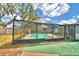 Enjoy the sparkling pool, surrounded by a screened enclosure and a spacious patio for outdoor gatherings at 842 Cinnamon Dr, Winter Haven, FL 33880
