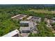 An aerial view showing the property's architecture and surrounding lush greenery at 100 El Camino Dr # 309, Winter Haven, FL 33884