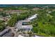 An aerial view showcases the property's architecture, pond, surrounding greenery, and convenient parking at 100 El Camino Dr # 309, Winter Haven, FL 33884