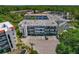 Aerial view of condo complex with multiple buildings, landscaping, and parking at 100 El Camino Dr # 309, Winter Haven, FL 33884