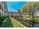 Condo building overlooking a canal with lush landscaping and water views at 100 El Camino Dr # 309, Winter Haven, FL 33884