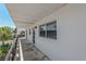 Balcony with views of mature palms and tropical landscaping on a sunny day at 100 El Camino Dr # 309, Winter Haven, FL 33884