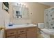 Bathroom with a vanity, decorative mirror and shower with flower curtain at 100 El Camino Dr # 309, Winter Haven, FL 33884