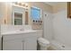 Clean bathroom with a white vanity, mirror, and a walk-in shower at 100 El Camino Dr # 309, Winter Haven, FL 33884