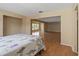 Bedroom with laminate floors showcasing view to living room and windows at 100 El Camino Dr # 309, Winter Haven, FL 33884