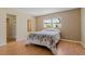 Cozy bedroom features bright window, spacious closet, and laminate floors at 100 El Camino Dr # 309, Winter Haven, FL 33884