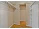 Spacious walk-in closet with built-in shelving and clothing rods for ample storage at 100 El Camino Dr # 309, Winter Haven, FL 33884