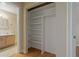 Bedroom closet with open shelves next to bathroom with a pedestal sink at 100 El Camino Dr # 309, Winter Haven, FL 33884