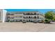 Multi-story condo building with ample parking and manicured landscaping at 100 El Camino Dr # 309, Winter Haven, FL 33884