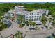 A view showcases the building's exterior design, parking area, and surrounding greenery at 100 El Camino Dr # 309, Winter Haven, FL 33884
