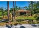 Charming single-story home with mature trees, a manicured front yard, and inviting walkway leading to the entrance at 100 El Camino Dr # 309, Winter Haven, FL 33884