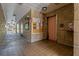 Tiled hallway with access to elevators and community bulletin board at 100 El Camino Dr # 309, Winter Haven, FL 33884