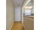 Hallway with wood floors leading to the front door and a glimpse of the kitchen with wood countertops at 100 El Camino Dr # 309, Winter Haven, FL 33884