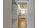Hallway with storage leading to bright kitchen with barstool seating area at 100 El Camino Dr # 309, Winter Haven, FL 33884