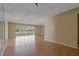Bright, open living room with wood-look floors and large windows showcasing natural light at 100 El Camino Dr # 309, Winter Haven, FL 33884