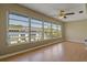 Living room featuring a wall of windows offering views and natural light at 100 El Camino Dr # 309, Winter Haven, FL 33884