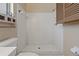 Bright white shower with updated showerhead and storage in updated bathroom at 100 El Camino Dr # 309, Winter Haven, FL 33884