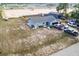 Aerial view of a home and expansive lot, showcasing the property's spaciousness and potential at 100 Ellen Ct, Winter Haven, FL 33884