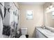 Clean bathroom featuring a toilet, vanity with sink, and a decorative shower curtain at 100 Ellen Ct, Winter Haven, FL 33884