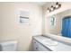 Bright bathroom featuring modern sink with gray countertop, vanity, and matching framed mirror at 100 Ellen Ct, Winter Haven, FL 33884