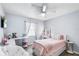 Bright bedroom featuring a ceiling fan, light gray walls, and a cozy pink bedspread at 100 Ellen Ct, Winter Haven, FL 33884