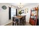 Dining room with wooden table, decorative wall art, a liquor cabinet, and wood-look tile flooring at 100 Ellen Ct, Winter Haven, FL 33884