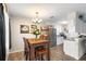 Cozy dining area featuring a wooden table, chandelier, and bar with wine rack near the kitchen at 100 Ellen Ct, Winter Haven, FL 33884