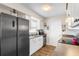 Bright kitchen with stainless steel appliances, white cabinets, and wood-look tile flooring at 100 Ellen Ct, Winter Haven, FL 33884