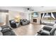 Spacious living room with hardwood flooring, a brick fireplace, and plush seating, ideal for relaxation at 100 Ellen Ct, Winter Haven, FL 33884