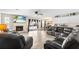 Spacious living room with a cozy brick fireplace, recessed lighting, and plush seating, perfect for entertaining and relaxation at 100 Ellen Ct, Winter Haven, FL 33884