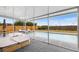 Screened-in patio overlooking a fenced-in pool with lounge chairs and lush landscaping at 100 Ellen Ct, Winter Haven, FL 33884