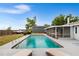 Relaxing backyard pool with lounge chairs and screened-in lanai, perfect for outdoor entertainment at 100 Ellen Ct, Winter Haven, FL 33884