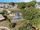 Aerial view of the property featuring the house and screened-in pool at 102 Lake Ring Dr, Winter Haven, FL 33884
